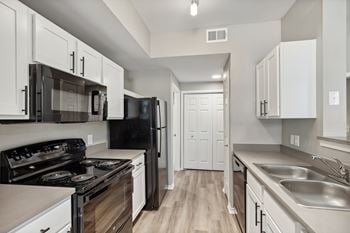 Sleek kitchen appliances, including microwave and dishwasher